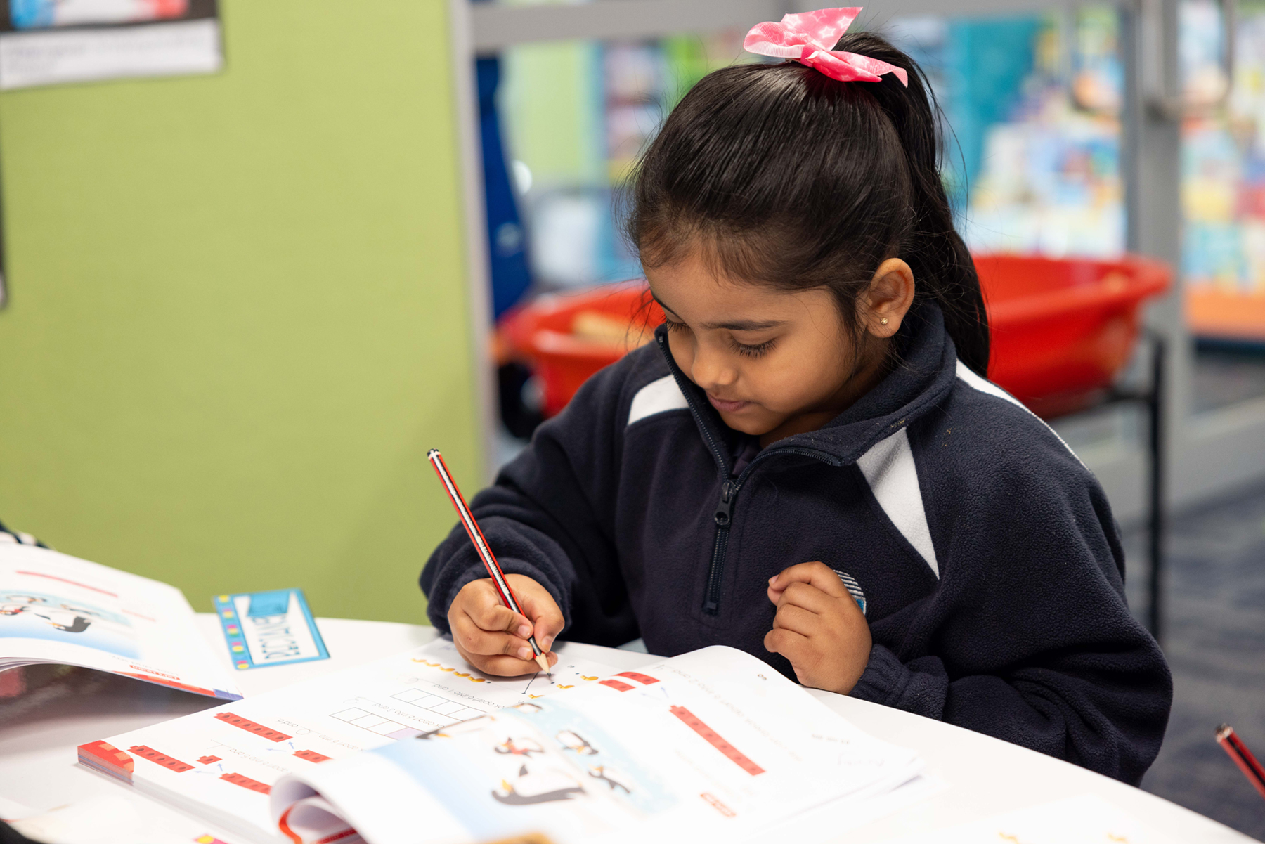 Student with Math Workbook the heart of our school