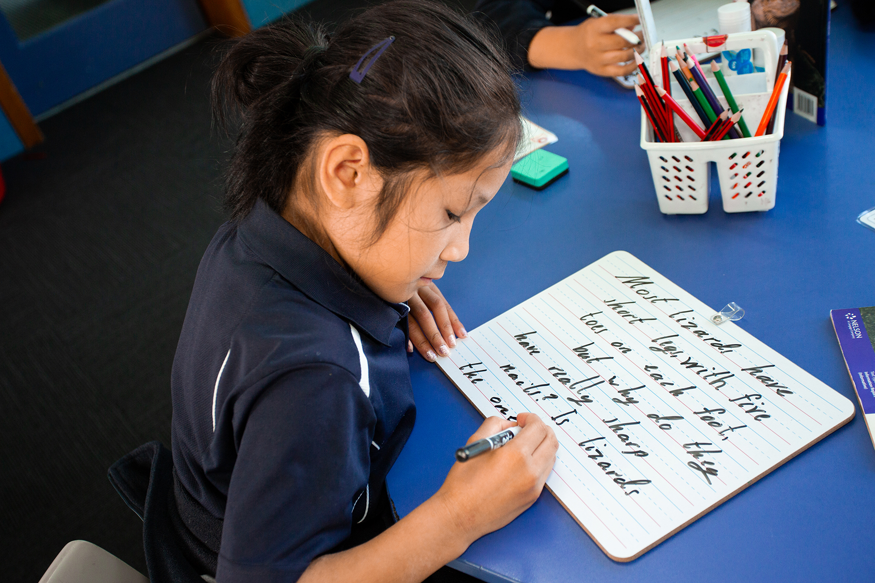 Girl Writing on Whiteboard striving for excellence
